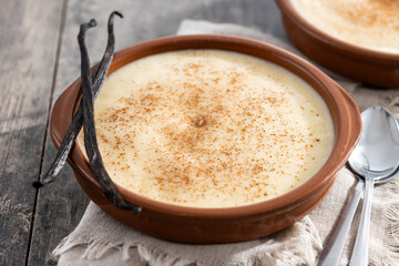 Creamy homemade Spanish custard served in a bowl on wooden table