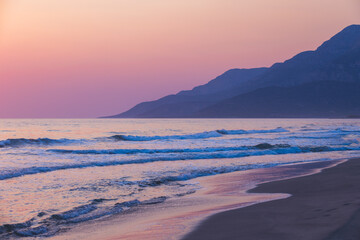 Tranquil seaside scene featuring gentle waves, a sandy shoreline