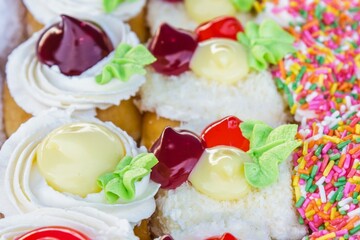 Close up of colorful cupcakes with frosting and sprinkles