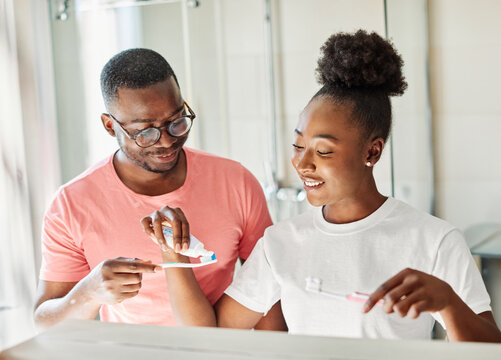 Portrait of a young black couple cleaning brushing their teeth in front of mirror in bathroom. Dental hygiene, youth, ove and beauty concepts