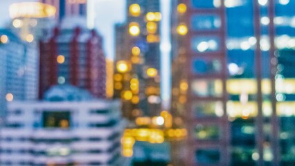 Blurred cityscape at night with glowing windows