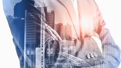 Double exposure of business person and city skyline