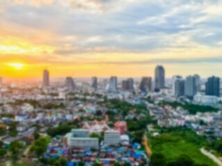 Fototapeta premium City skyline at sunset with golden sun and clouds