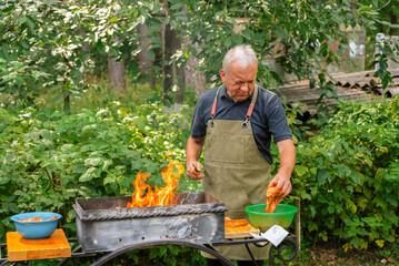 Man grilling barbecue in garden setting