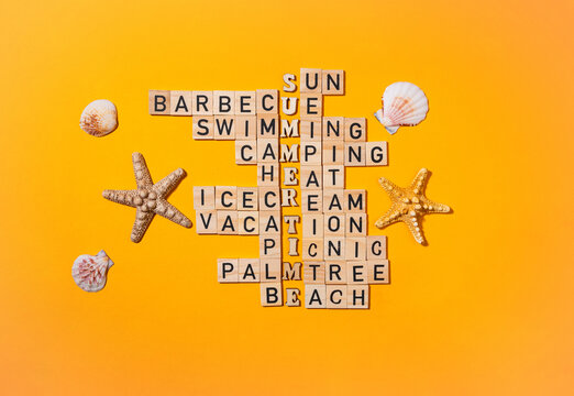 Crossword puzzle with wooden blocks and seashells