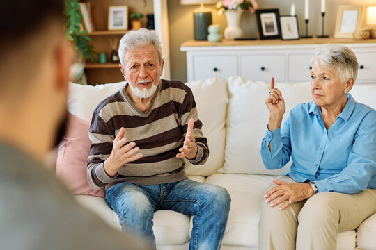 Mature couple consultation session with health therapiest or doctor at home or in doctor's office, or an insurance real estate agent