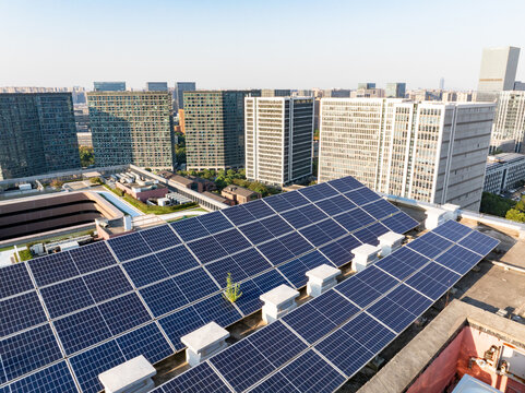 modern office building with solar power station on rooftop - Powered by Adobe