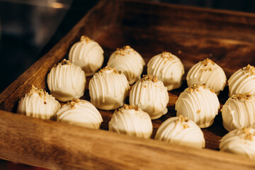 White chocolate truffles displayed in a cafe showcase