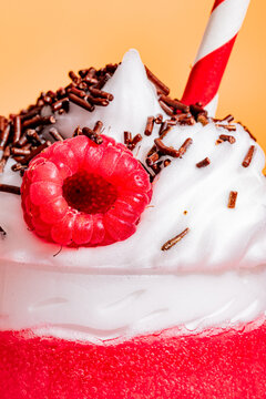 Raspberry smoothie with whipped cream and toppings