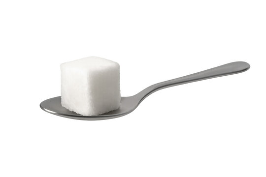 Sugar cube resting on a metal spoon, representing sweetness, unhealthy consumption, diet, glucose, and food ingredient