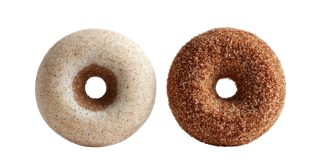Two ring-shaped baked treats on a dark background