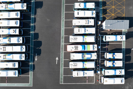 Fototapeta Aerial view of electric buses parked in an orderly parking lot