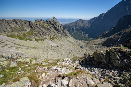 Aerial view of rugged peaks pierce the sky, casting shadows on the valley below in Jahnaci stit peak, Vysoke Tatry, Presov Region, Slovakia.