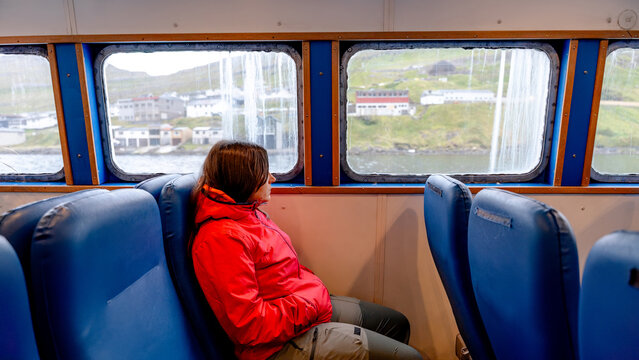 Woman enjoying the ferry ride in the Faroe Islands