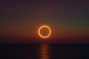 Ring eclipse over calm ocean horizon