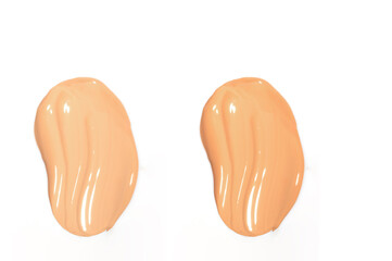 Creamy foundation smear on a pristine white surface, showcasing its luxurious texture and perfect pigment