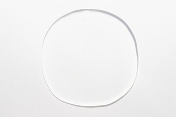 A single droplet of clear serum circular smear on a white isolated background, purity, hydration of modern skincare, cosmetic swatch