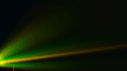Vibrant Green and Yellow Light Beams on Dark Background