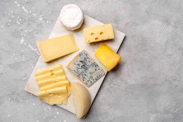 Italian and French gourmet cheese platter with craft cheese assortment on a marble platter. hard cheeses, mold cheese, gorgonzola, pecorino, Emmental, Roquefort cheddar