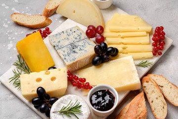 Italian and French gourmet cheese platter with craft cheese assortment on a marble platter. hard cheeses, mold cheese, gorgonzola, pecorino, Emmental, Roquefort cheddar