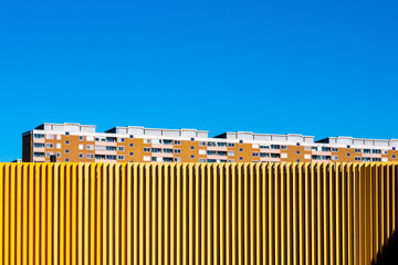 Architecture and geometry frame a stockholm facade where contrast, color and minimalism interplay, illuminated by hard light and unified through the graphic rhythm of urban pattern and modern design