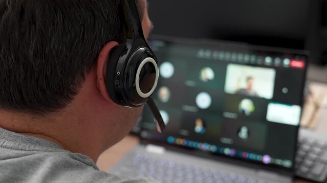 Man wearing headset participating in online video conference