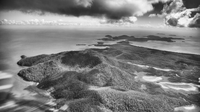 Monochrome aerial view of Queensland coastline showing ocean shapes and striking abstract formations