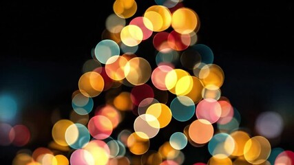 A cone-shaped arrangement of colorful overlapping out-of-focus lights against a solid black background - Powered by Adobe