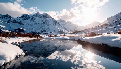 A tranquil winter scene unfolds with majestic snow-covered mountains mirrored in the glassy surface of a stream, bathed in the soft light of a sunlit sky.