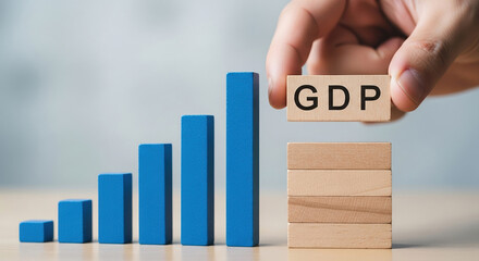 Gross domestic product GDP block being added to rising bar graph, economic growth, financial analysis, smart investment, and a successful strategy for increasing profit in stock market and banking