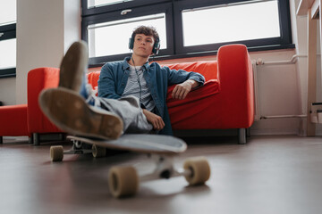 High school student chilling with headphones.