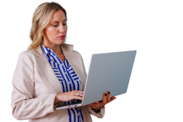 Focused businesswoman standing, using a laptop for remote work or online business. She is engaged with technology. Transparent background