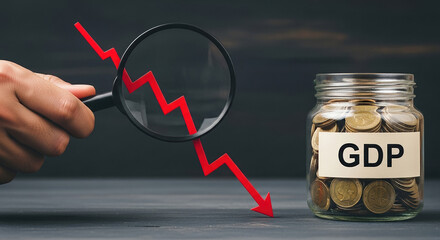 Magnifying glass highlights red arrow declining over jar of coins labeled Gross Domestic Product GDP, indicating financial analysis