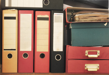 Messy file folders, ring binders grungy paperwork.Red tape, bureaucracy, overworked, beat the clock business concept, free copy space