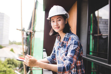 woman inspector or engineer checking on inspection paper in construction site in the building