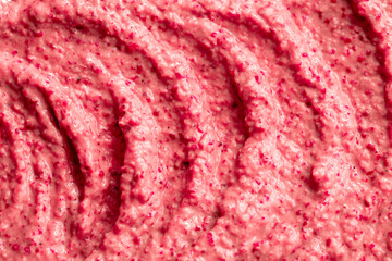 Fruit pink ice cream. Yogurt smoothie with fresh fruits and berries. Ice cream texture. Delicious sweet dessert close-up as background.
