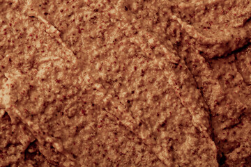Chocolate ice cream with nuts and banana, texture. Chocolate smoothie cocktail close-up. Nut paste as a background.