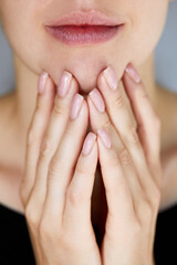 Cosmetology, beauty. Skin care. Manicure and Hands Spa. Beautiful model girl with a manicure nails. Woman natural makeup and care for hands cosmetics. Facial treatment .