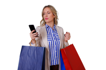 Woman shopping, carrying various colored paper bags and looking at her mobile phone. Transparent background