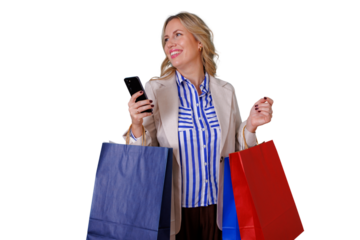 Happy woman holding shopping bags and mobile phone while looking away, enjoying retail therapy and sales