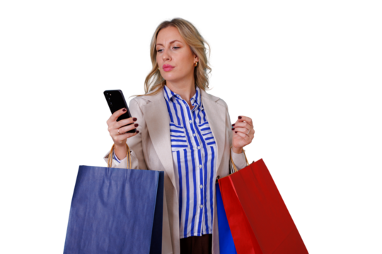 Woman shopping, carrying various colored paper bags and looking at her mobile phone. Transparent background