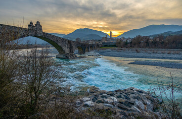 The Hunchback Bridge (also called the Old Bridge or the Devil's Bridge) at sunset in Bobbio, province of Piacenza, Emilia-Romagna, Italy