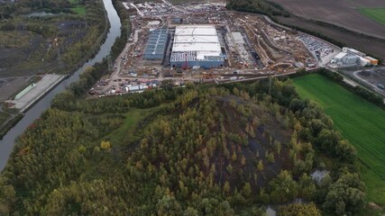 The new data center in Farciennes, Belgium, is a major investment focused heavily on AI, cloud services, and sustainability carbon free energy, waste heat recovery, solar panels. Aerial drone video