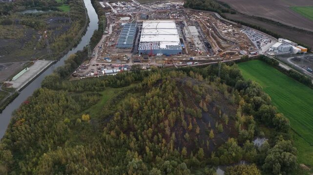 The new data center in Farciennes, Belgium, is a major investment focused heavily on AI, cloud services, and sustainability carbon free energy, waste heat recovery, solar panels. Aerial drone video