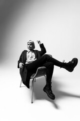 A person sits gracefully in a stylish chair, exuding confidence and personality