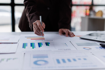 Hand og Many charts and graphs. Reflection light and flare. Concept image of data gathering and statistical working.