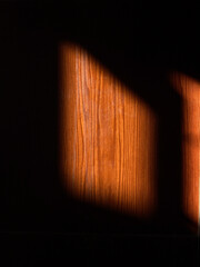 Warm Sunlight Casting Shadows on Wood Grain Surface