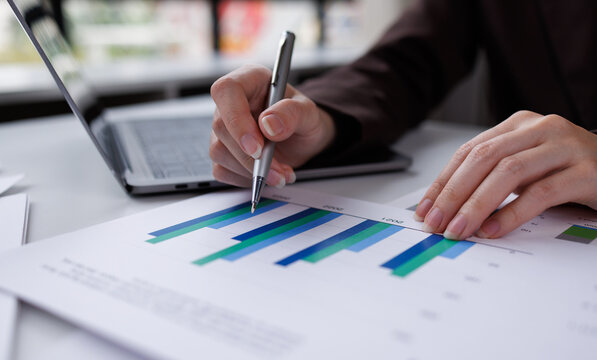 financial officer checking calculator with paper documents to review business annual report in office

 - Powered by Adobe