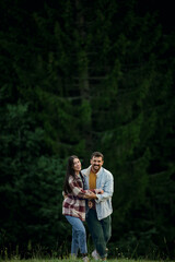 Happy couple enjoying nature smiling in forest