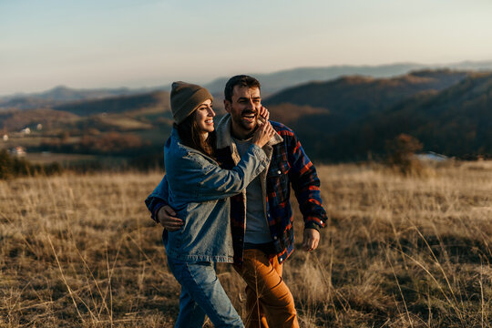 Happy couple enjoying outdoor hike in autumn landscape